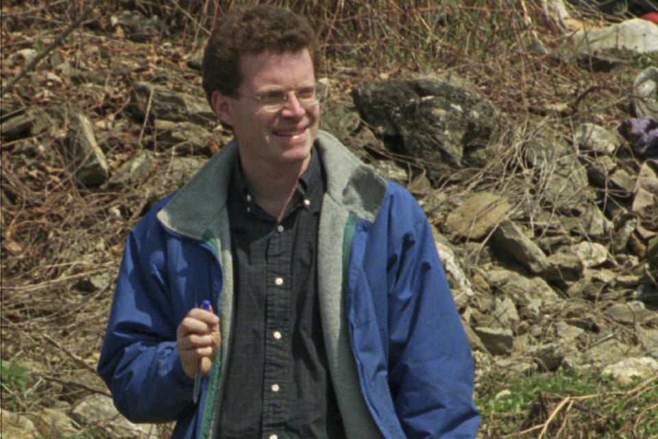 FILE - This April 9, 1996, file photo shows David Rohde, then of The Christian Science Monitor, at a mass grave site in Kravice, Bosnia. Rohde, reporting for the New York Times, and two other men were kidnapped at gunpoint in Afghanistan in 2008. U.S. authorities announced Wednesday, Oct. 28, 2020, that an Afghan man, Haji Najibullah, has been brought to the United States to face charges in the kidnapping. The victims were not identified, but the description matched the kidnapping of Rohde and Afghan journalist Tahir Ludin. (AP Photo/Vadim Ghirda, File)