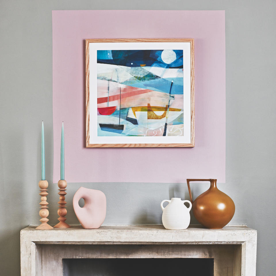 Enlarge the scale of a framed print above a fireplace