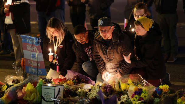 PHOTO: People hold a vigil at a makeshift memorial near the Club Q nightclub on Nov. 20, 2022 in Colorado Springs, Colorado. (Scott Olson/Getty Images)