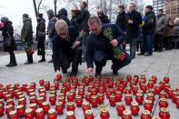 Mourners place lit candles as they arrive to attend a farewell ceremony for slain opposition leader Boris Nemtsov in Moscow, on March 3, 2015