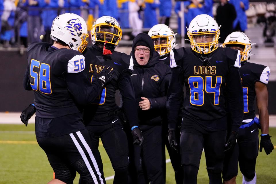 Gahanna Lincoln's Jake Grimm (58) and Eddie Blunt (84) congratulate Makai Shahid (6) after he returned a kickoff for a touchdown during a 25-17 win over New Albany in the Division I, Region 3 final Nov. 18 at Historic Crew Stadium. The Lions play Lakewood St. Edward in a state semifinal Nov. 25 at Arlin Field in Mansfield.