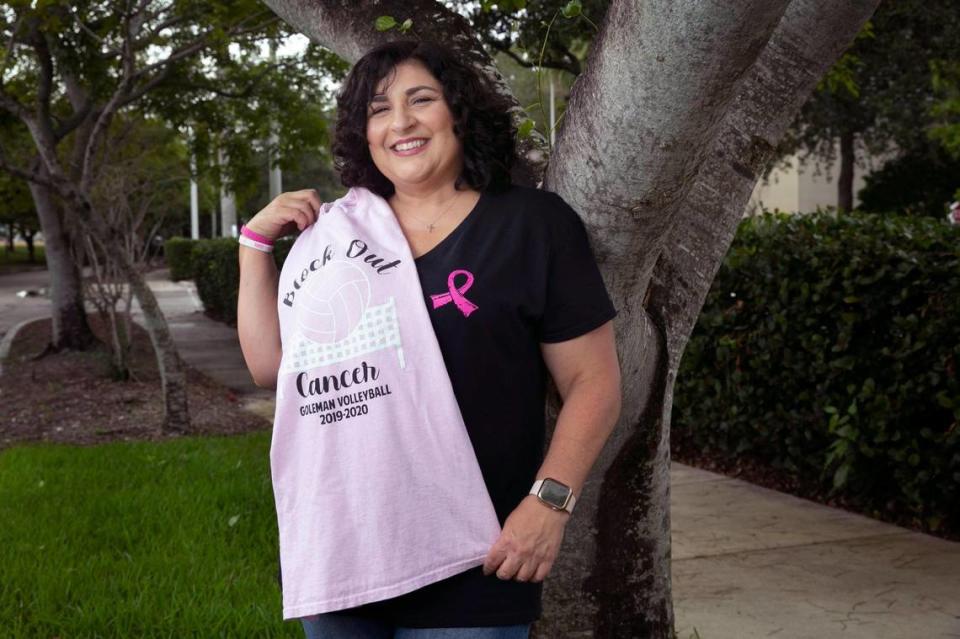 Marlen Acosta-Garcia, a breast cancer survivor and patient of Dr. Lauren Carcas at Baptist Health’s Miami Cancer Institute Plantation location, holds a T-shirt from Barbara Goleman Senior High in Miami Lakes, where she now teaches law and is the assistant volleyball coach, on Oct, 8, 2021.