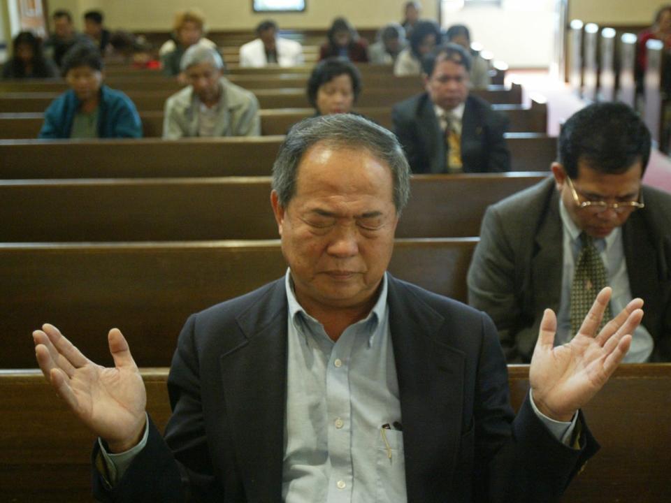 Ted Ngoy worships at the East Side Christian Church in Long Beach in November, 2004.