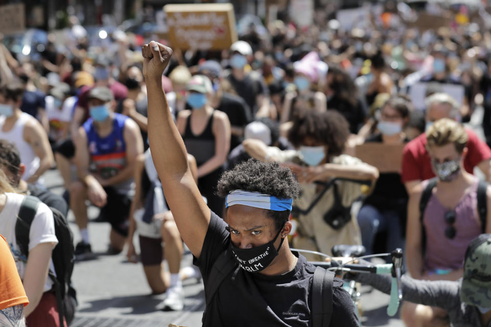 Protesters march through the streets of Manhattan, New York, Sunday, June 7, 2020. New York City lifted the curfew spurred by protests against police brutality ahead of schedule Sunday after a peaceful night, free of the clashes or ransacking of stores that rocked the city days earlier. (AP Photo/Seth Wenig)