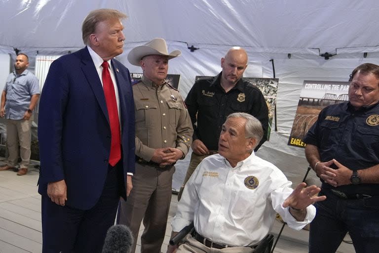 Trump escucha las explicaciones del gobernador de Texas, Greg Abbott, en Eagle Pass, Texas. (AP Photo/Eric Gay)