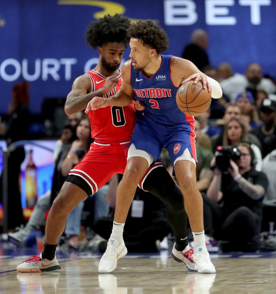 Detroit Pistons guard Cade Cunningham (2) drives against Chicago Bulls guard Coby White (0) during first-quarter action at Little Caesars Arena in Detroit on Saturday, Oct. 28, 2023.