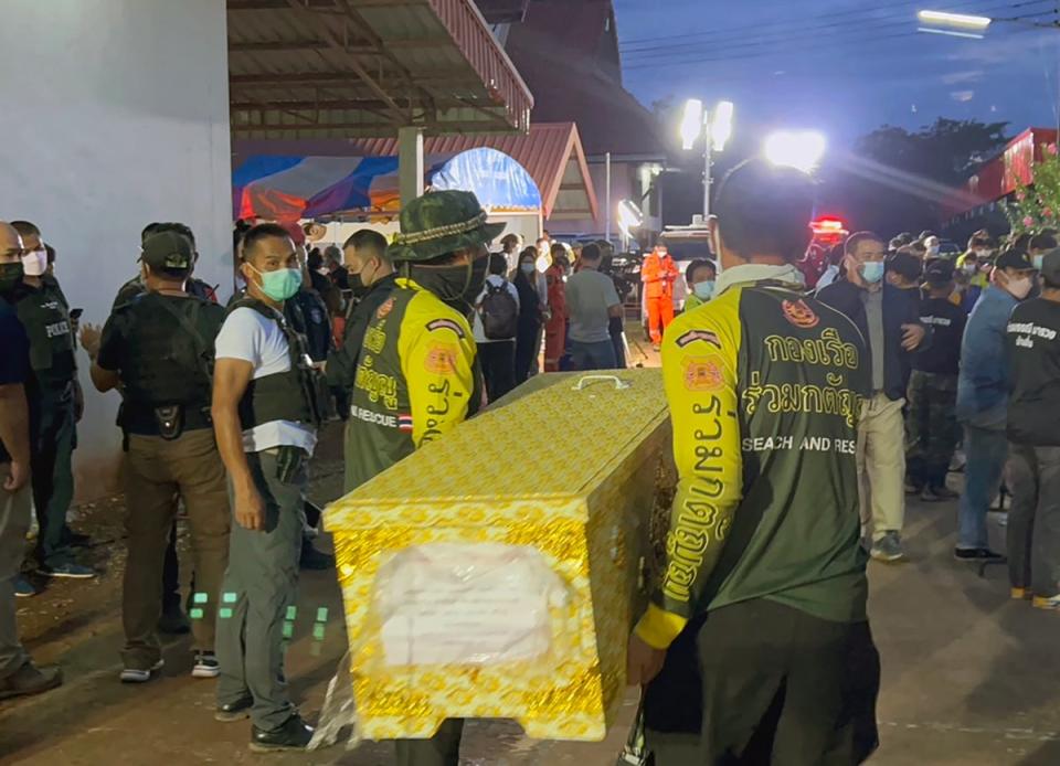 Thai rescue workers carry a coffin containing from the daycare centre in Nong Bua Lamphu (EPA)