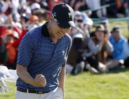 International team member Bae Sang-moon of South Korea reacts after sinking his putt to defeat U.S. team member Rickie Fowler and Jimmy Walker on the 18th hole during the four ball matches of the 2015 Presidents Cup golf tournament at the Jack Nicklaus Golf Club in Incheon, South Korea, October 9, 2015. REUTERS/Toru Hanai