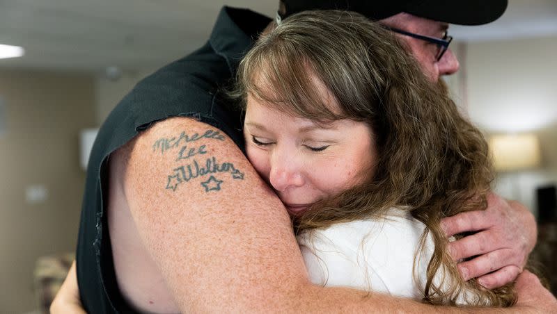 Tasha Cram hugs Mike Walker at the Presidential Club Condos in Salt Lake City on Saturday, July 8, 2023. After losing her twin at age 4, Cram is on a journey to give 1,000 healing hugs to twins across the U.S.