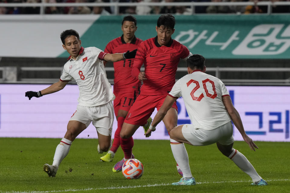 South Korea's Son Heung-min fights for the ball against Vietnam's Do Hung Dung, left, during an international friendly soccer match in Suwon, South Korea, Tuesday, Oct. 17, 2023. (AP Photo/Ahn Young-joon).