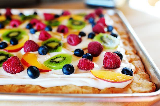 <p>Pizza is one of the easiest and best dinners around—and turns out, it can be an amazing dessert, too! All you need is a crust and some sweet toppings. Like the savory kind, sweet pizza is easy to make your own. But if you need some inspiration, use these dessert pizza recipes as a starting point and create your own combos. (Psst, if you're looking for savory topping ideas, check out what Ree Drummond's restaurant <a href="https://www.thepioneerwoman.com/ree-drummond-life/a32109305/ree-drummond-p-town-pizza-hours-location-menu/" rel="nofollow noopener" target="_blank" data-ylk="slk:P-Town;elm:context_link;itc:0" class="link ">P-Town</a> has on the menu—the <a href="https://www.thepioneerwoman.com/food-cooking/recipes/a36098211/fig-and-arugula-pizza-recipe/" rel="nofollow noopener" target="_blank" data-ylk="slk:fig and arugula pizza;elm:context_link;itc:0" class="link ">fig and arugula pizza</a> is amazing!)<br></p><p>First things first, you need a crust: The base of a dessert pizza can be made with a traditional <a href="https://www.thepioneerwoman.com/food-cooking/recipes/a36080815/basic-pizza-dough-recipe/" rel="nofollow noopener" target="_blank" data-ylk="slk:basic pizza dough;elm:context_link;itc:0" class="link ">basic pizza dough</a>, or something sweeter, like sugar cookie dough or brownie batter. Some of the crusts on dessert pizzas aren't even crusts at all. For instance, you can use a big slab of melon as a base!<br></p><p>Next up, it's time for the toppings: Arguably the best part of any pizza, toppings are what make each pie unique. In the case of these dessert pizza recipes, we're not talking about sauce, cheese, and veggies—these crusts are topped with fruit, chocolate, marshmallows, and other confections. If you’ve never made a sweet treat like this before, you’ve come to the right place. Try one of these delicious dessert pizza recipes tonight! <br></p>
