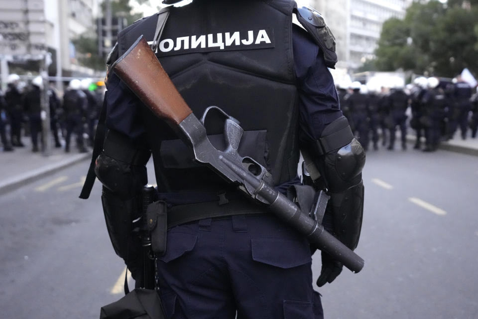 Serbian police guards the area as demonstrators take the streets to protest potential new COVID-19 restrictions announced by the government in Belgrade, Serbia, Saturday, Sept. 18, 2021. (AP Photo/Darko Vojinovic)