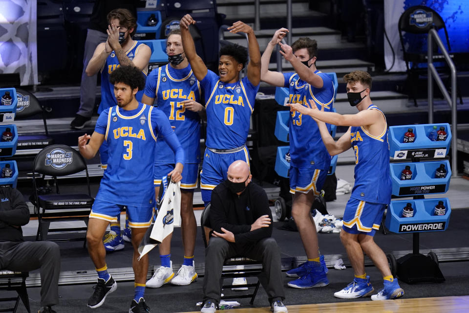 UCLA players react to a play against Alabama in overtime duiring a Sweet 16 game in the NCAA men's college basketball tournament at Hinkle Fieldhouse in Indianapolis, Sunday, March 28, 2021. (AP Photo/AJ Mast)