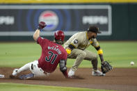 Arizona Diamondbacks' Jake McCarthy (31) slides safely into second with a run-scoring double as San Diego Padres second baseman Luis Arraez, right, reaches for a late throw during the fourth inning of a baseball game Sunday, May 5, 2024, in Phoenix. (AP Photo/Ross D. Franklin)