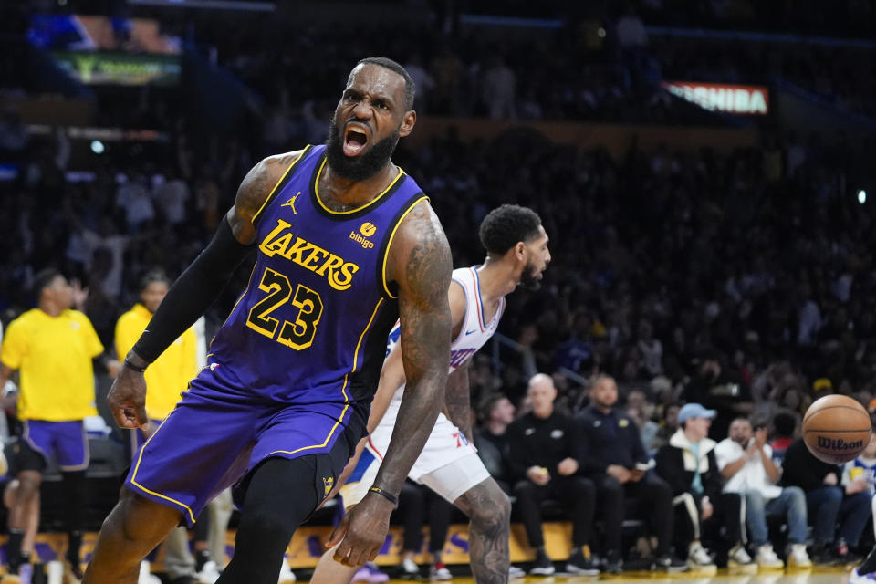 Los Angeles Lakers forward LeBron James (23) celebrates his dunk against the Philadelphia 76ers during the first half of an NBA basketball game Friday, March 22, 2024, in Los Angeles. (AP Photo/Jae C. Hong)
