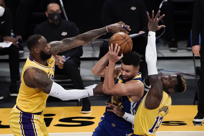 Los Angeles Lakers' LeBron James, left, and Dennis Schroder, right, defend against Golden State Warriors.