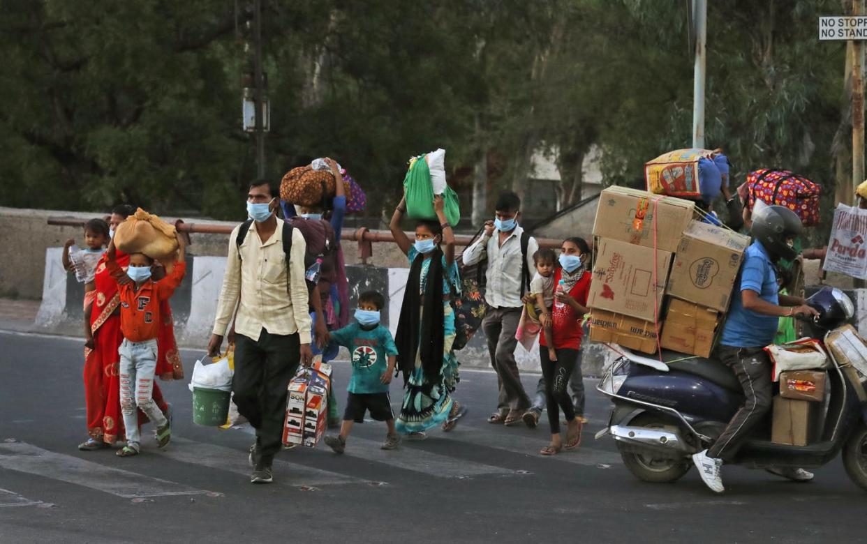 <span class="caption">Migrant workers leaving New Delhi to go back to their villages amid the coronavirus lockdown</span> <span class="attribution"><a class="link " href="http://www.apimages.com/metadata/Index/Virus-Outbreak-India/641feef1e52e400ea28bebee4004fa49/55/0" rel="nofollow noopener" target="_blank" data-ylk="slk:AP Photo/Manish Swarup;elm:context_link;itc:0;sec:content-canvas">AP Photo/Manish Swarup</a></span>