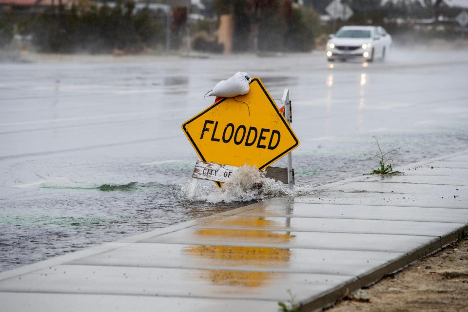 A sign warns motorists along Palm Drive in Desert Hot Springs on Thursday about flooding on the roadway.