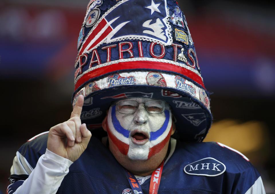 A New England Patriots fan celebrates while awaiting the start of the NFL Super Bowl XLIX football game against the Seattle Seahawks in Glendale