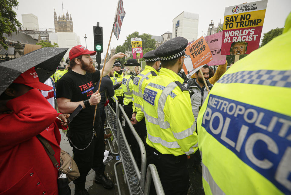 Pro and anti Donald Trump protesters are separated by a police line, in Parliament square in London, Tuesday, June 4, 2019. Trump will turn from pageantry to policy Tuesday as he joins British Prime Minister Theresa May for a day of talks likely to highlight fresh uncertainty in the allies' storied relationship. (AP Photo/Tim Ireland)