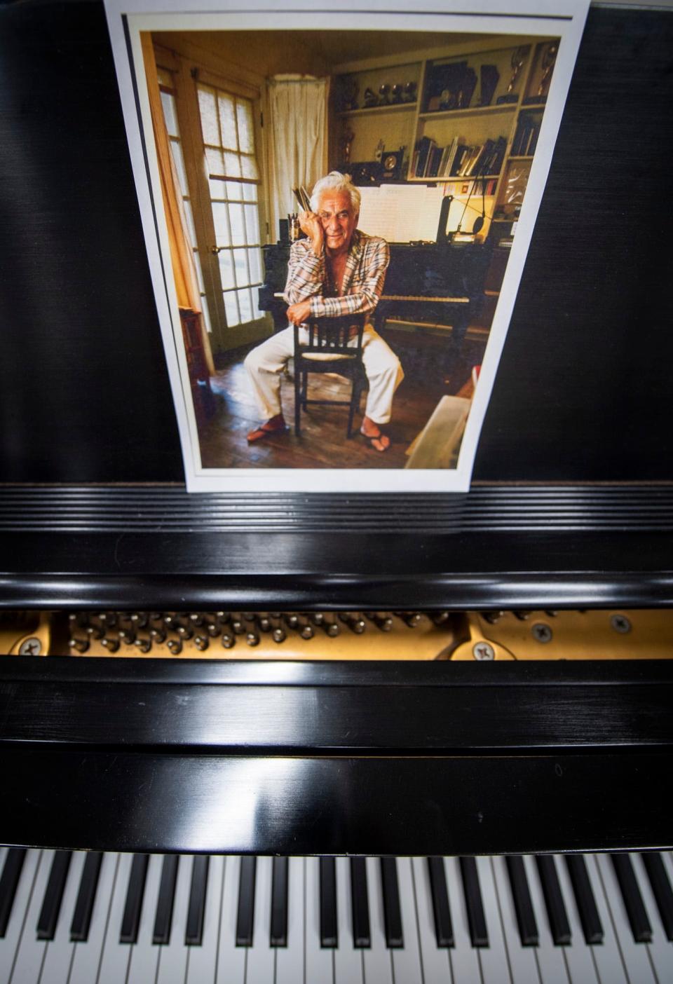 A portrait of Leonard Bernstein sits above one of his pianos as part of the Bernstein Collection at the Jacobs School of Music. He spent his life composing and conducting, and the collection's items come from his Fairfield, Conn., studio.