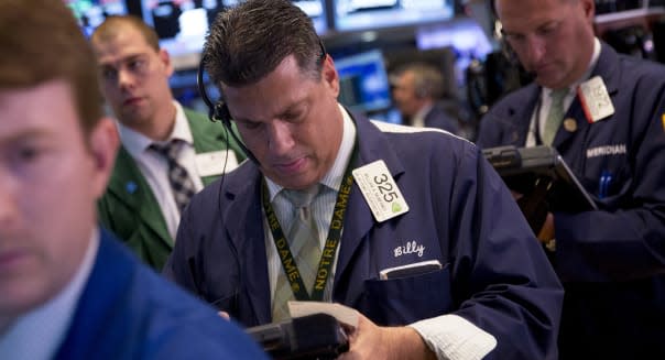 Traders work on the floor of the New York Stock Exchange (NYSE) in New York, U.S., on Wednesday, Aug. 21, 2013. U.S. stocks fell, giving the Dow Jones Industrial Average its longest slump in 13 months, as minutes of the Federal Reserve's July meeting showed officials support stimulus cuts this year if the economy improves. Photographer: Scott Eells/Bloomberg via Getty Images