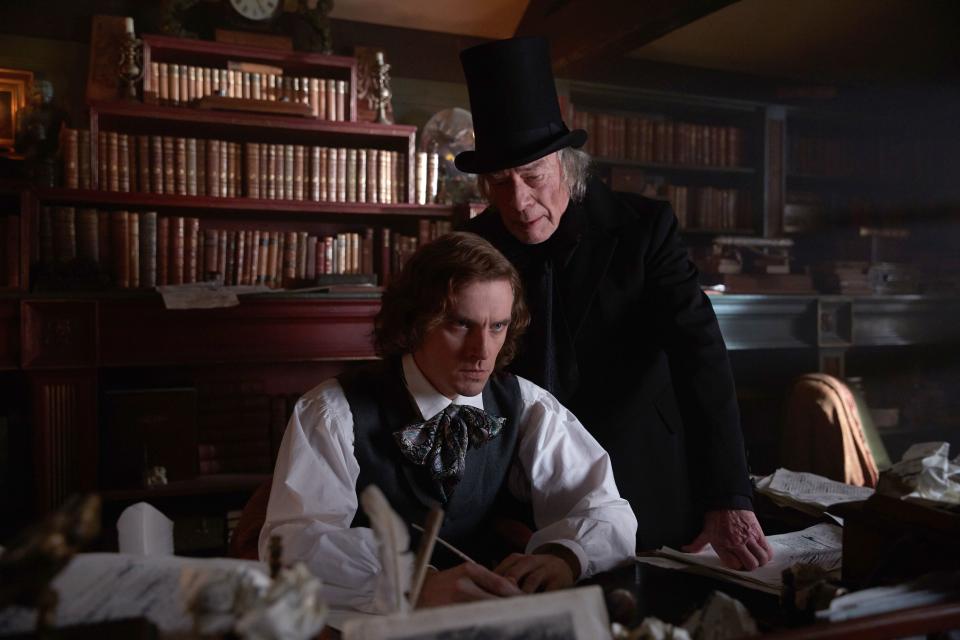 Dan Stevens, left, stars as Charles Dickens with Christopher Plummer as Ebenezer Scrooge in “The Man Who Invented Christmas.”