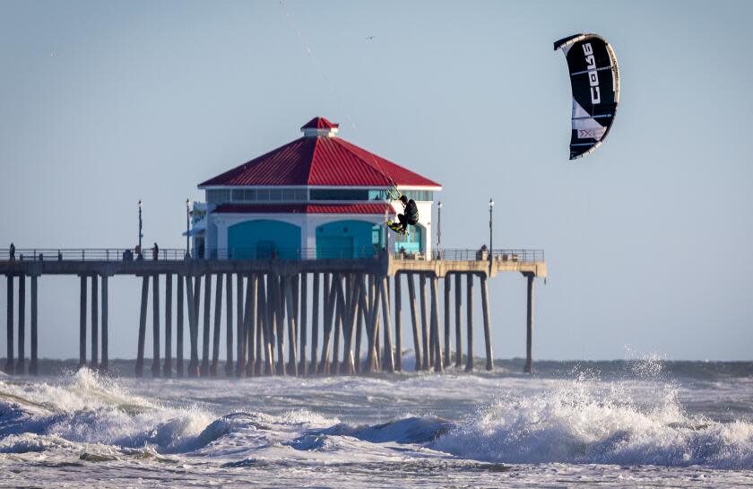 Huntington Beach, CA - January 07: A windsurfer takes advantage of strong, gusty winds to take flight amid high surf in in Huntington Beach Sunday, Jan. 7, 2024. (Allen J. Schaben / Los Angeles Times)