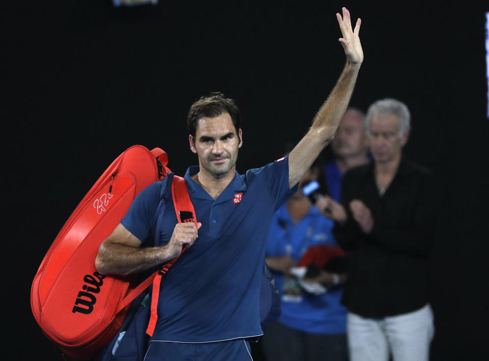Switzerland's Roger Federer waves as he leaves Rod Laver Arena after losing his fourth round match against Greece's Stefanos Tsitsipas at the Australian Open tennis championships in Melbourne, Australia, Sunday, Jan. 20, 2019. (AP Photo/Mark Schiefelbein)