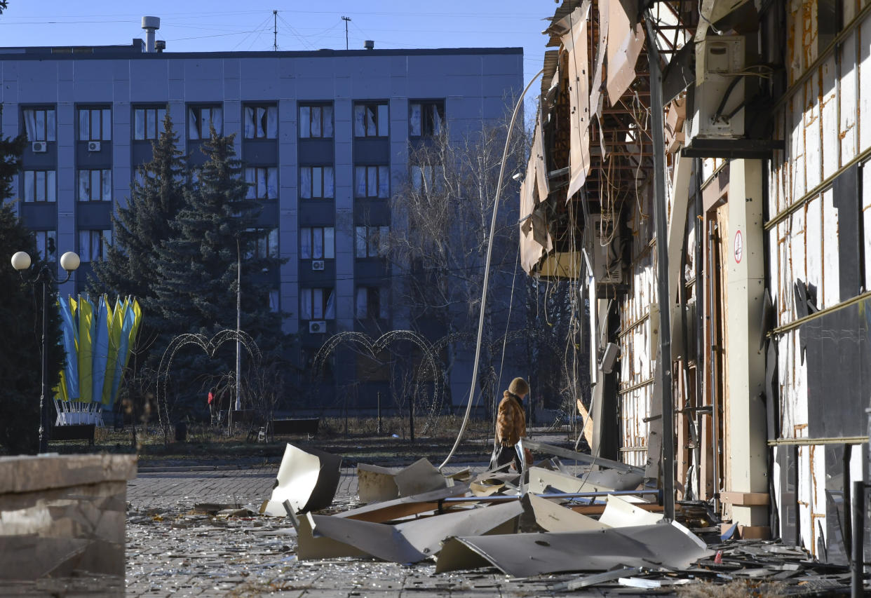 A local resident walks along a street in the area of the heaviest battles with the Russian invaders in Bakhmut, Ukraine, Tuesday, Dec. 20, 2022. (AP Photo/Andriy Andriyenko)