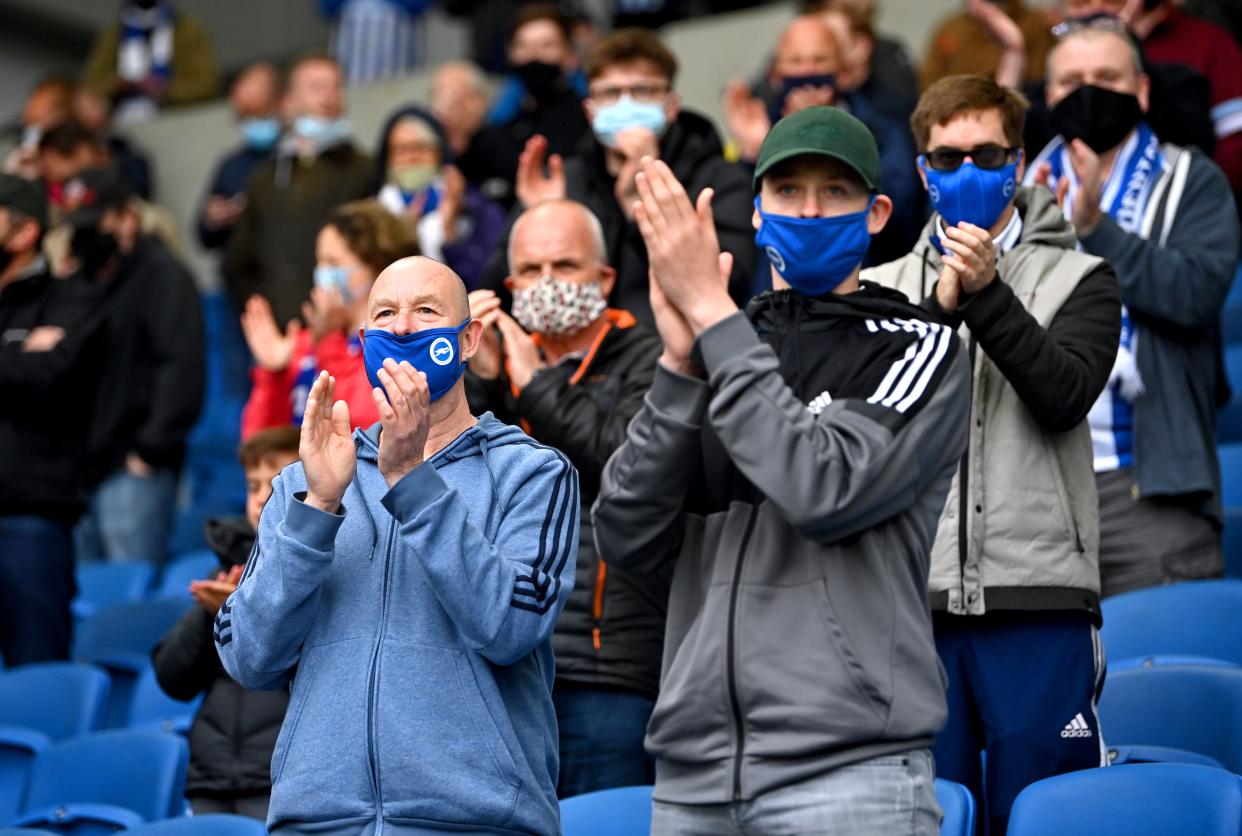 Fans in masks applaud their team (PA) (PA Wire)