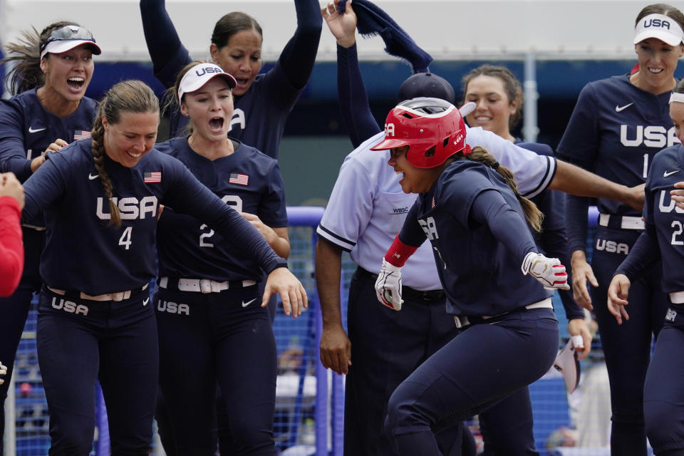 United States' Kelsey Stewart (7) is greeted at the plate by her teammates following her game winning home run against Japan in the seventh inning of a softball game at the 2020 Summer Olympics, Monday, July 26, 2021, in Yokohama, Japan. (AP Photo/Sue Ogrocki)