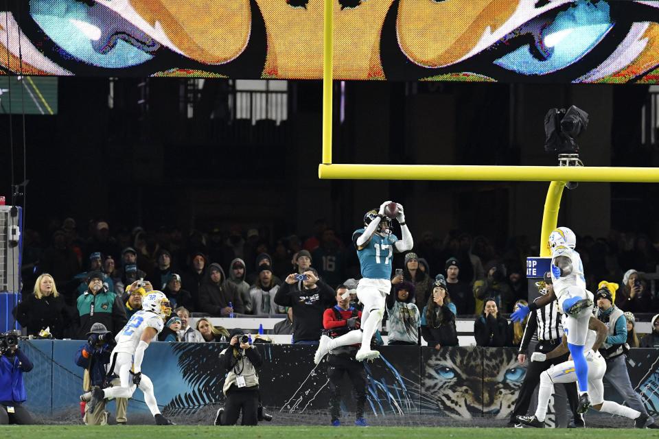 Jacksonville Jaguars tight end Evan Engram (17) pulls in a pass for a touchdown late in the second quarter. The Jacksonville Jaguars hosted the Los Angeles Chargers in their first round playoff game Saturday, January 14, 2023 at TIAA Bank Field in Jacksonville, Fla. The Jaguars trailed 27 to 7 at the half. [Bob Self/Florida Times-Union]