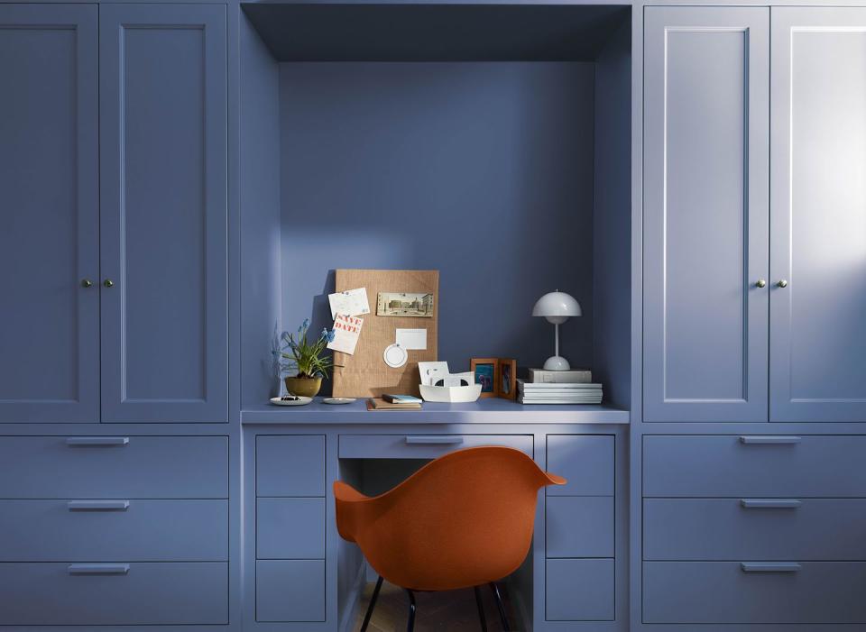 a chair in a room with white cabinets