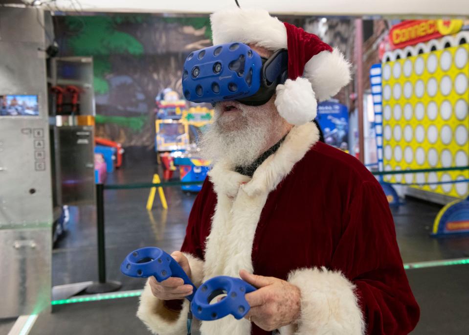 Santa tries his luck playing a virtual reality game at Splash City Adventures on Pensacola Boulevard on Wednesday, Nov. 29, 2023. Santa will join Joan and Reginald Benjamin at a Christmas party for children of incarcerated women hosted by Justified Incarcerated Ministries at Splash City Adventures on Dec. 16, 2023.