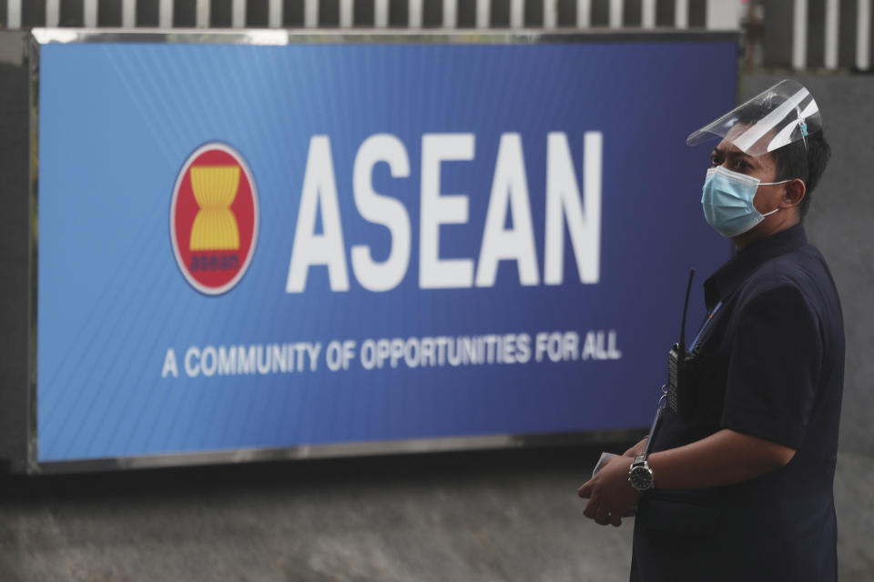 A security person stands outside the Association of Southeast Asian Nations (ASEAN) Secretariat in Jakarta, Indonesia, Monday, Oct. 25, 2021. Southeast Asian leaders are meeting this week for their annual summit where Myanmar's top general, whose forces seized power in February and shattered one of Asia's most phenomenal democratic transitions, has been shut out for refusing to take steps to end the deadly violence. (AP Photo/Achmad Ibrahim)