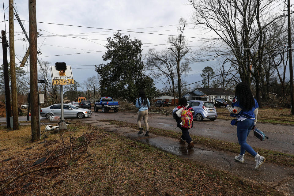 CORRECTS DAY OF WEEK TO THURSDAY, NOT WEDNESDAY - Kids walk home from school after a tornado hit near Meadowview elementary school Thursday, Jan. 12, 2023 in Selma, Ala. (AP Photo/Butch Dill)