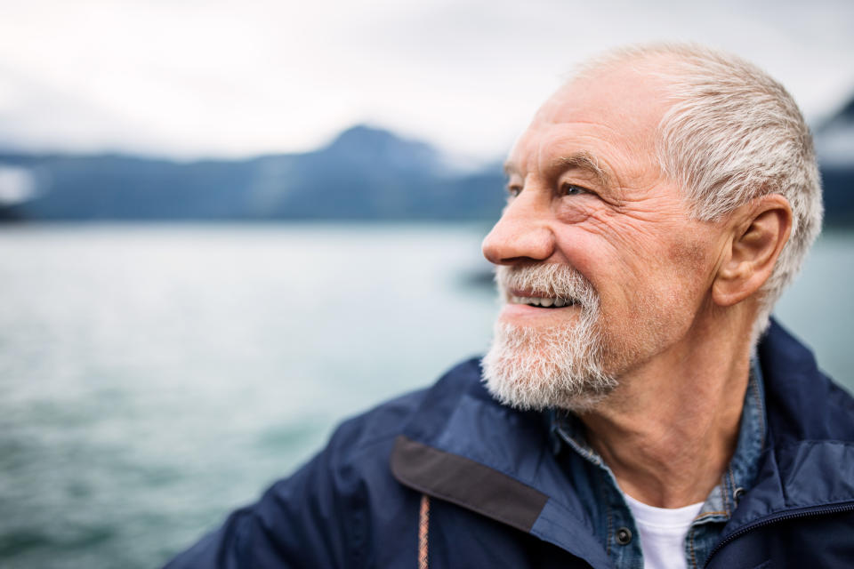 Front view of old man on a walk in summer.