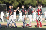 Stanford players celebrate after defeating Connecticut in an NCAA college baseball super regional tournament game on Sunday, June 12, 2022, in Stanford, Calif. (AP Photo/Kavin Mistry)