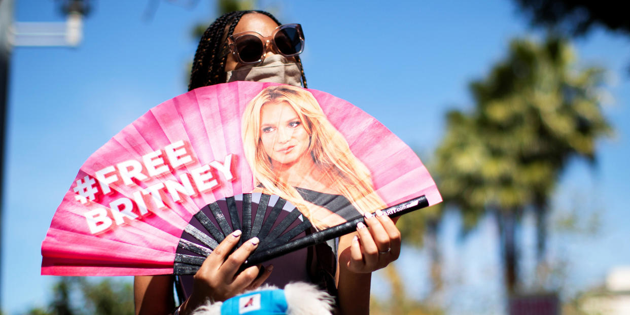 A supporter holds a fan while rallying for pop star Britney Spears during a conservatorship case hearing at Stanley Mosk Courthouse in Los Angeles (MARIO ANZUONI / Reuters)