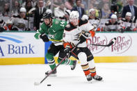 Anaheim Ducks defenseman John Klingberg (3) controls the puck as Dallas Stars left wing Jamie Benn (14) follows in the second period of an NHL hockey game, Monday, Feb. 6, 2023, in Dallas. (AP Photo/Tony Gutierrez)