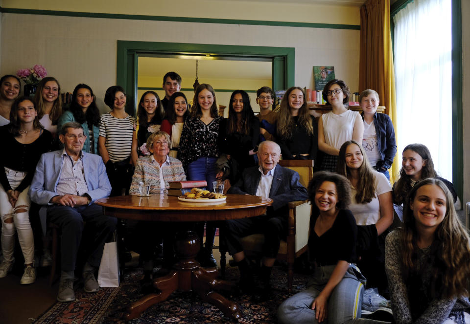 Jacqueline van Maarsen, center left, and Albert Gomes de Mesquita, center right, school friends of Anne Frank, pose for a photo with students from the International School of Amsterdam during an event to mark what would have been Anne Frank's 90th birthday, in Amsterdam on Wednesday, June 12, 2019. On the day Anne Frank would have turned 90, the museum dedicated to keeping alive her story has brought together schoolchildren and two of the Jewish diarist's friends at the apartment where she lived with her family before going into hiding from Nazis who occupied the Netherlands during World War II. (AP Photo/Michael C. Corder)