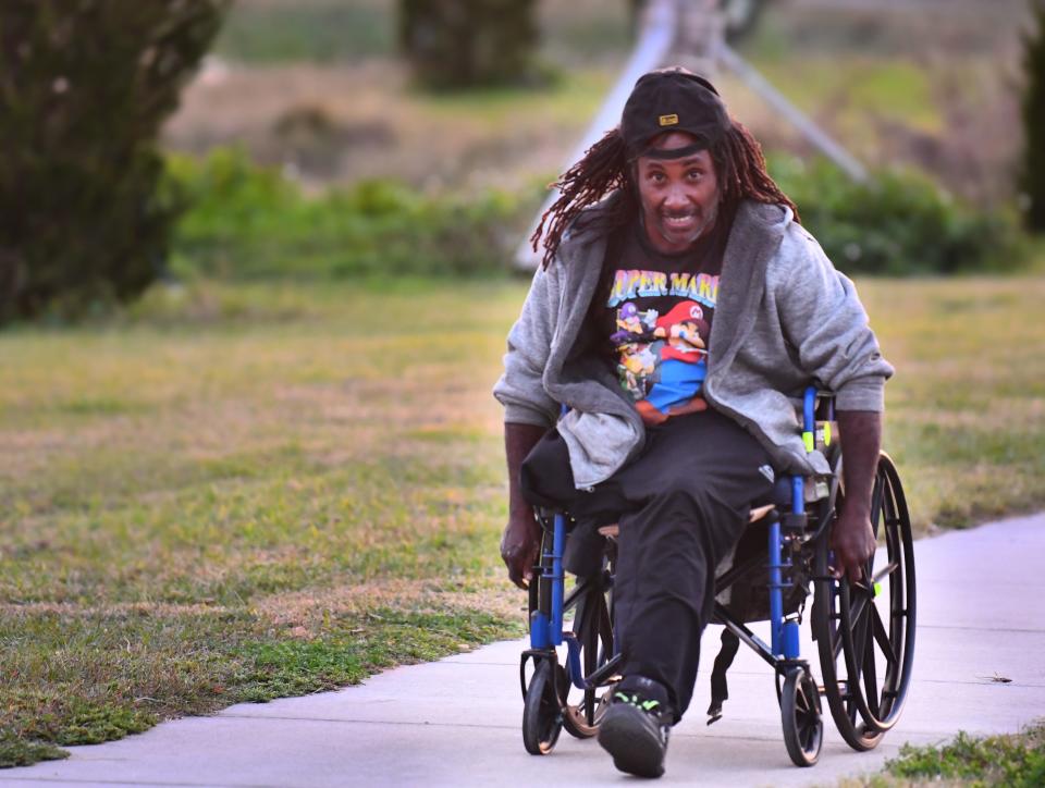 Carl Brown, 49, of Titusville, is homeless and travels by wheelchair. On Monday nights, he wheels his way to Sand Point Park to get a hot meal, along with spiritual and physical support, at a weekly event hosted by volunteers with the Under the Bridge Ministry.