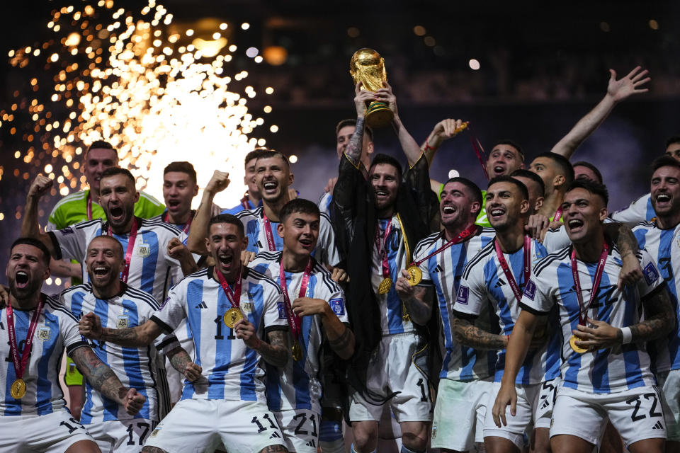 Argentina's Lionel Messi holds up the trophy after winning the World Cup final soccer match between Argentina and France at the Lusail Stadium in Lusail, Qatar, Sunday, Dec.18, 2022. (AP Photo/Manu Fernandez)