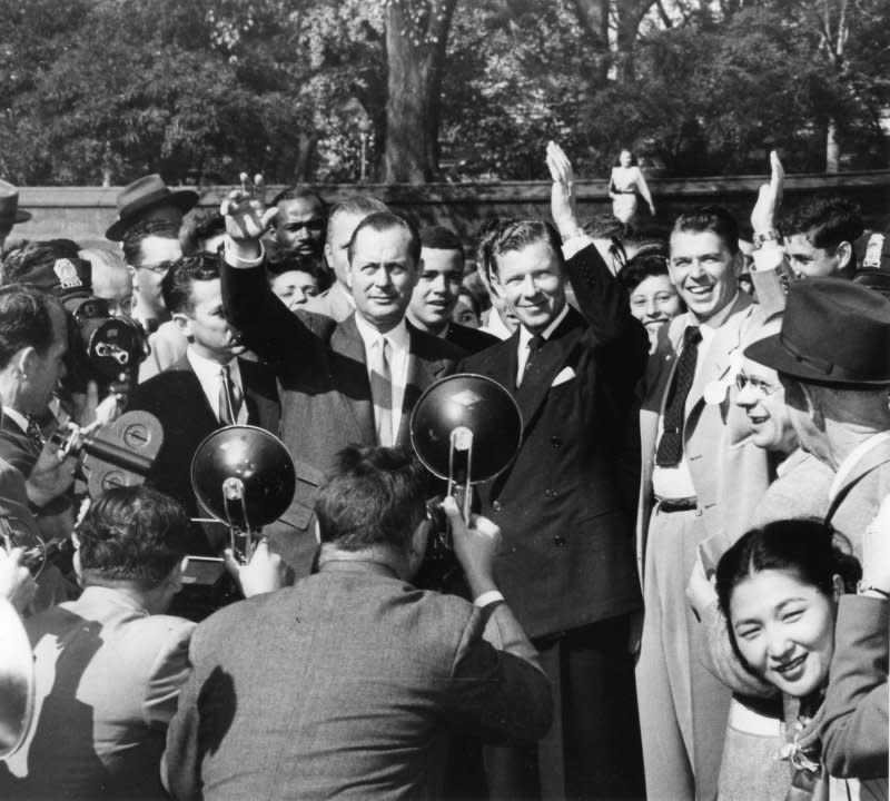 Screen stars Robert Montgomery, George Murphy and Ronald Reagan (L-R) are surrounded by fans and media as they leave the Capitol on October 23, 1947, after testifying before the House UnAmerican Activities Committee. The hearings began October 20, 1947. UPI File Photo