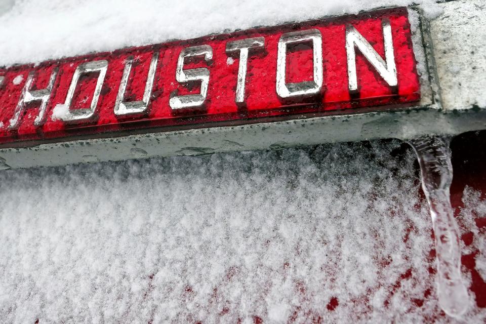 A sign is covered in ice and snow Monday, Feb. 15.