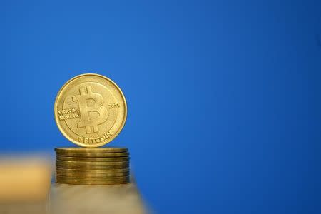 Bitcoin (virtual currency) coins are seen in an illustration picture taken at La Maison du Bitcoin in Paris July 11, 2014. REUTERS/Benoit Tessier/Files