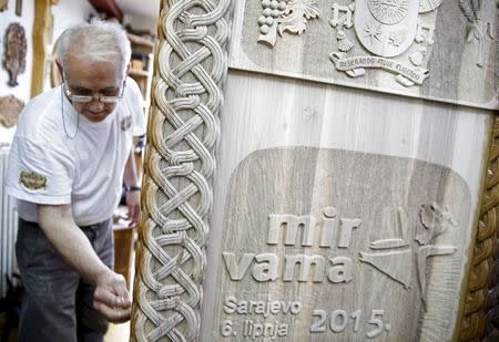 Bosnian wood carver-sculptor Salem Hajderovac works on a chair for Pope Francis, at his workshop in Zavidovici, Bosnia and Herzegovina, in this May 25, 2015 file photo. REUTERS/Dado Ruvic/Files