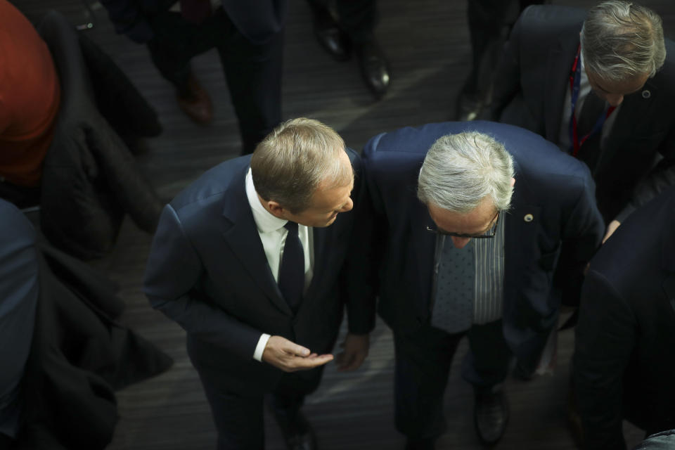 European Council President Donald Tusk, left, and European Commission President Jean-Claude Juncker speak with each other as they walk to a media conference at the conclusion of an EU summit in Brussels, Friday, March 22, 2019. European Union leaders gathered again Friday after deciding that the political crisis in Britain over Brexit poses too great a threat and that action is needed to protect the smooth running of the world's biggest trading bloc. (AP Photo/Francisco Seco)