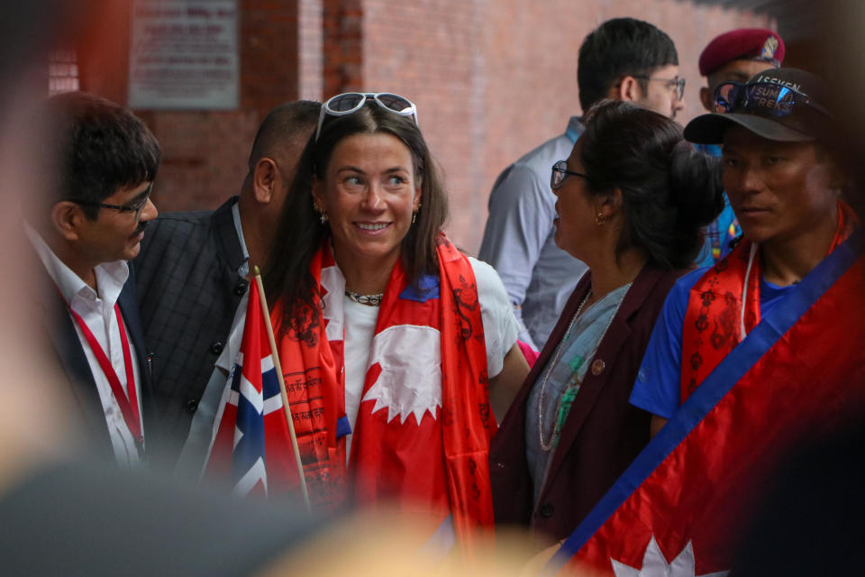 Norwegian climber Kristin Harila and Tenjen Sherpa, set the record for the fastest summit of all 14 of the world's 8,000-meter peaks, along with the youngest K2 summiteer, Nima Rinji Sherpa, arrival at the Tribhuvan International Airport in Kathmandu on August 5, 2023. / Credit: Sanjit Pariyar/NurPhoto via Getty Images